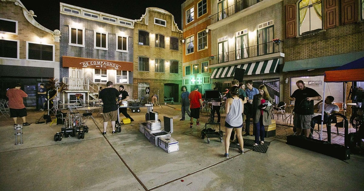 A film crew works on a sound stage.